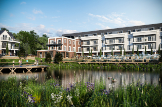 Architectural CGI - View of a modern residential complex next to a calm lake, featuring a bridge and people engaging in various activities. Lush greenery and wildflowers are visible in the foreground.